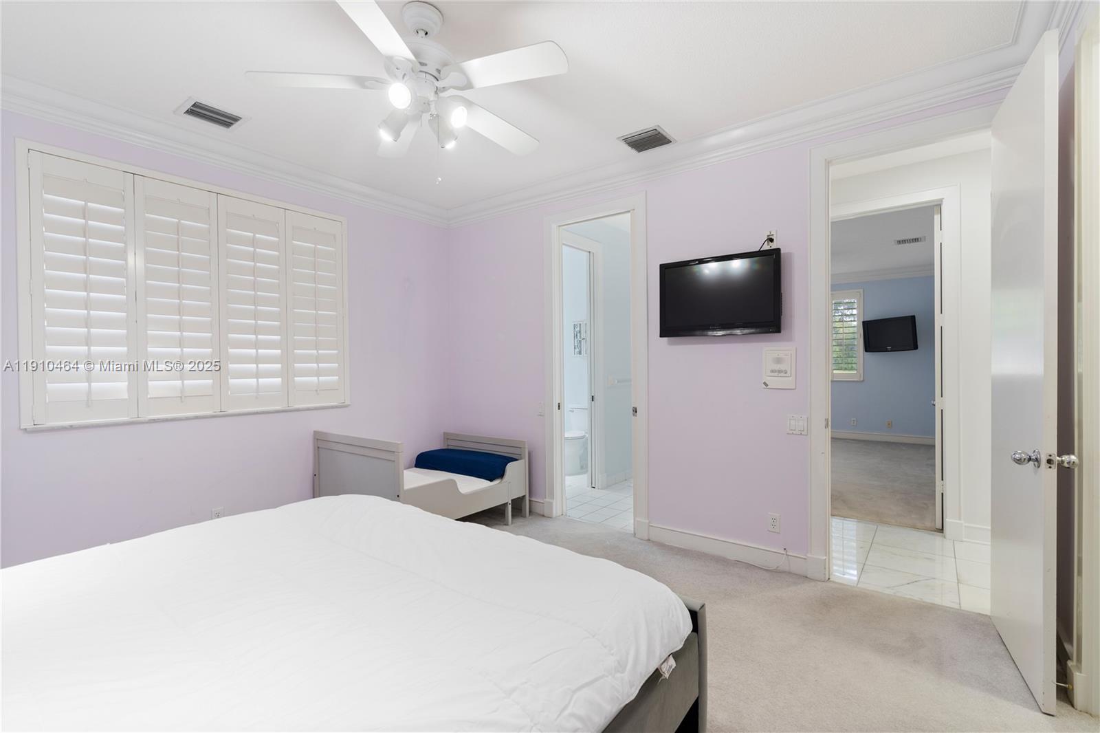 2939 Paddock Lane Weston, FL 33331 - Photo 52 of 59 a bedroom with a bed and a flat screen tv