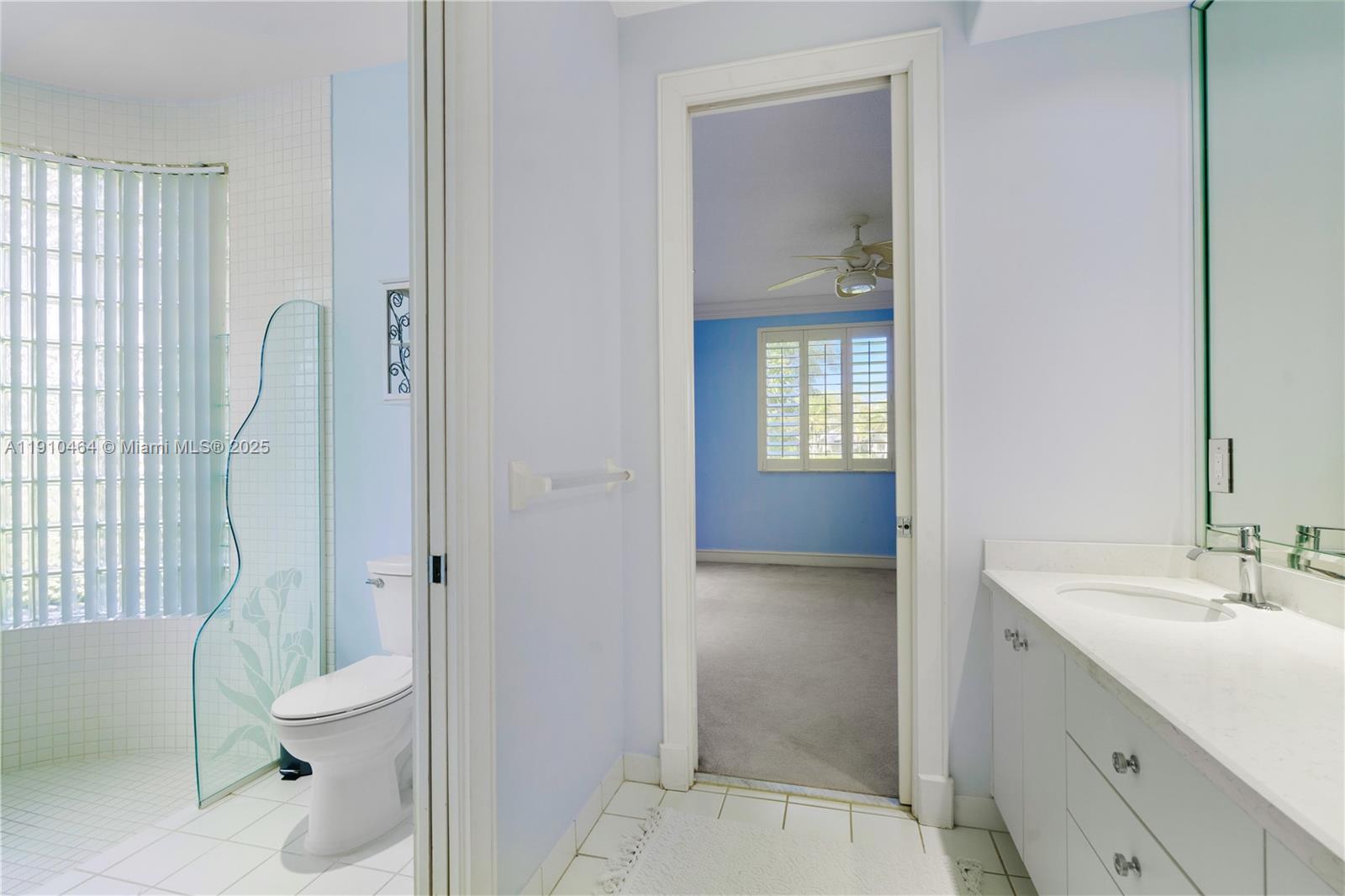 2939 Paddock Lane Weston, FL 33331 - Photo 53 of 59 a bathroom with a granite countertop toilet a sink and a mirror