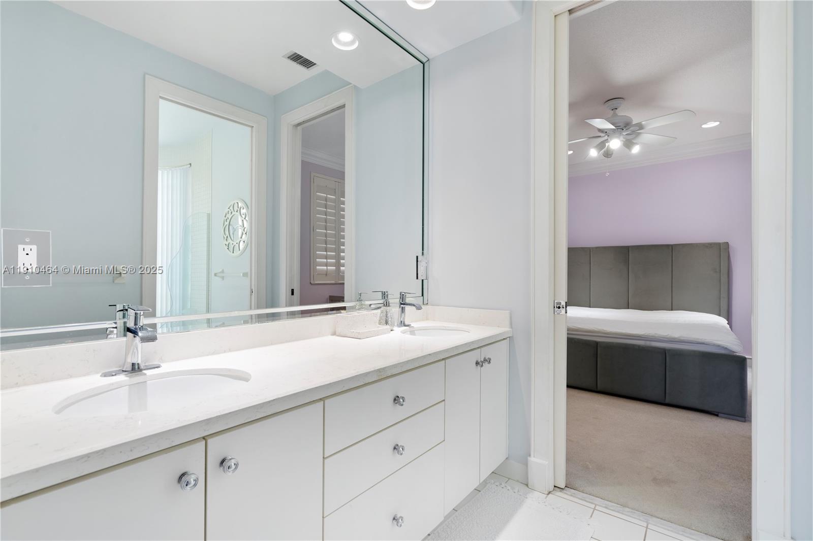 2939 Paddock Lane Weston, FL 33331 - Photo 55 of 59 a bathroom with a double vanity sink a mirror and a bathtub
