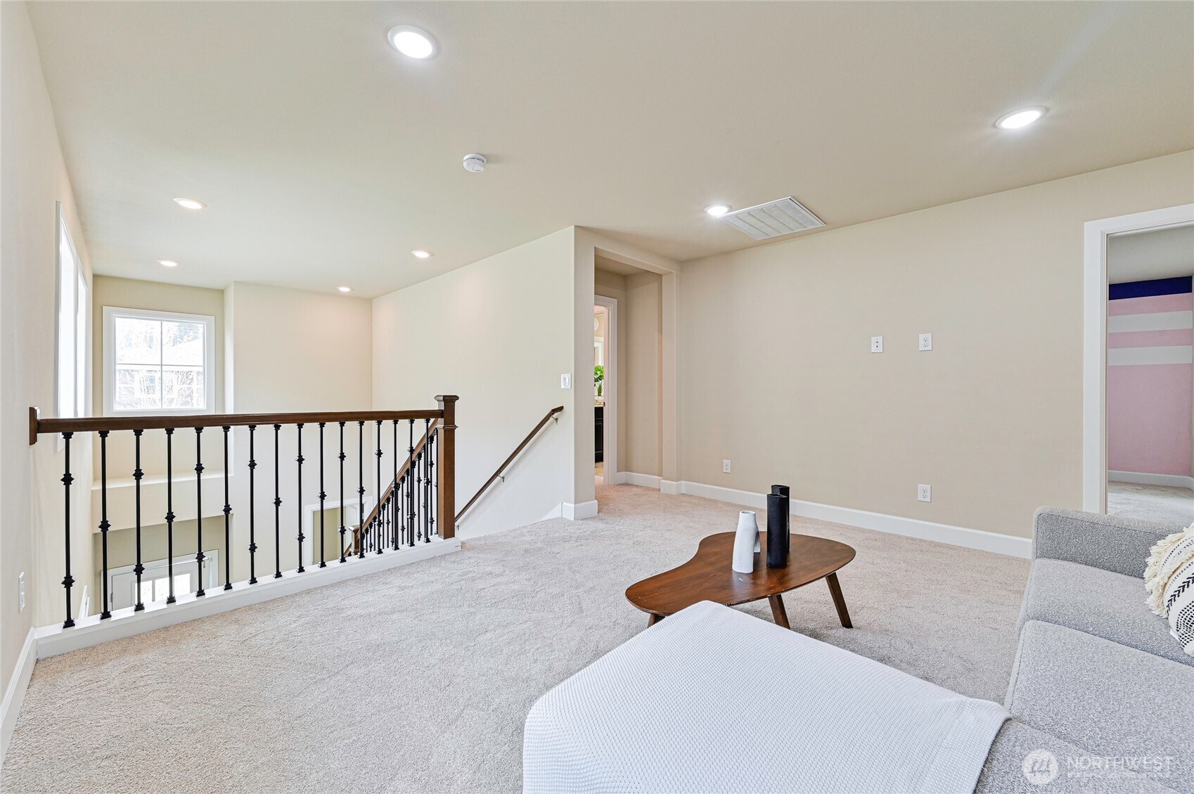 17312 40th Avenue Southeast Bothell, WA 98012 - Photo 16 of 34 a view of a hallway with couches and a potted plant on a table