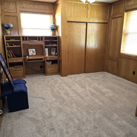 a living room with furniture a window and a book shelf