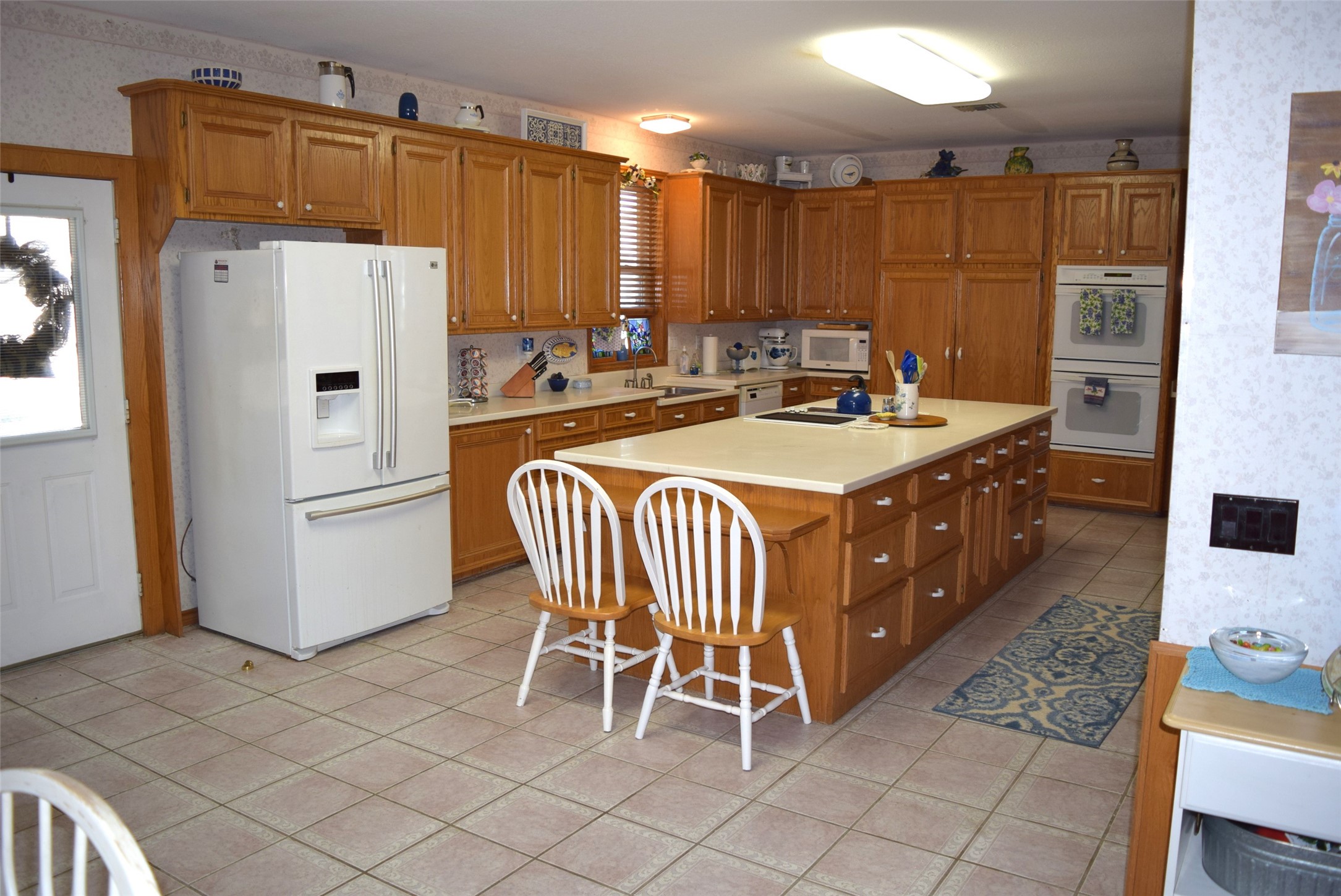 26 Westpoint Drive Trinity, TX 75862 - Photo 20 of 49 a kitchen with a sink a refrigerator and chairs