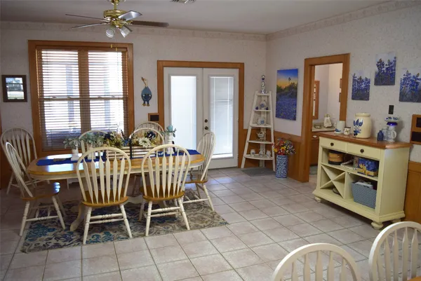 a dining room with furniture a chandelier and window