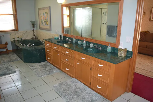 a bathroom with a sink vanity and mirror