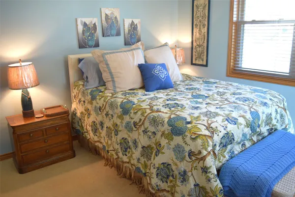 a bed sitting in a bedroom next to a window