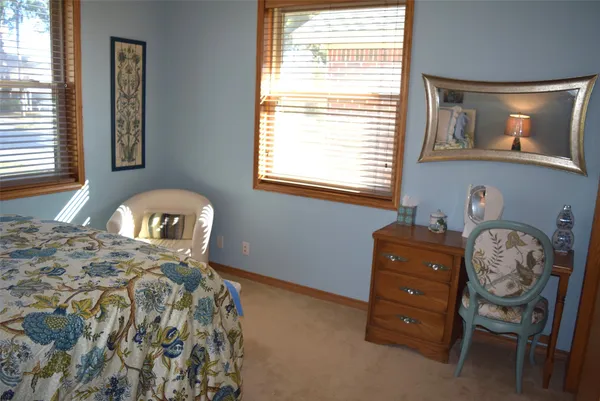 a bedroom with a bed and dresser
