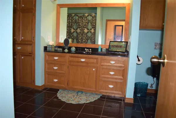 a bathroom with a sink a vanity and window