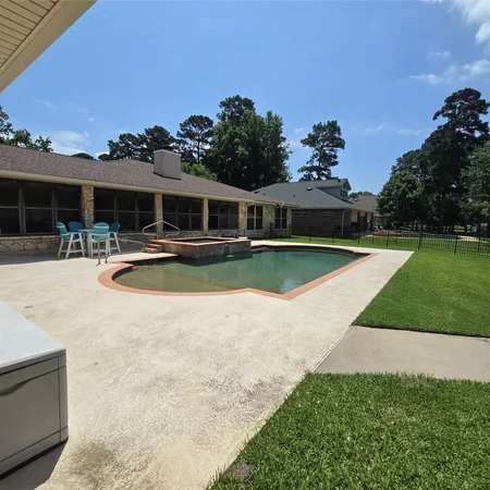 a view of a house with swimming pool and a yard