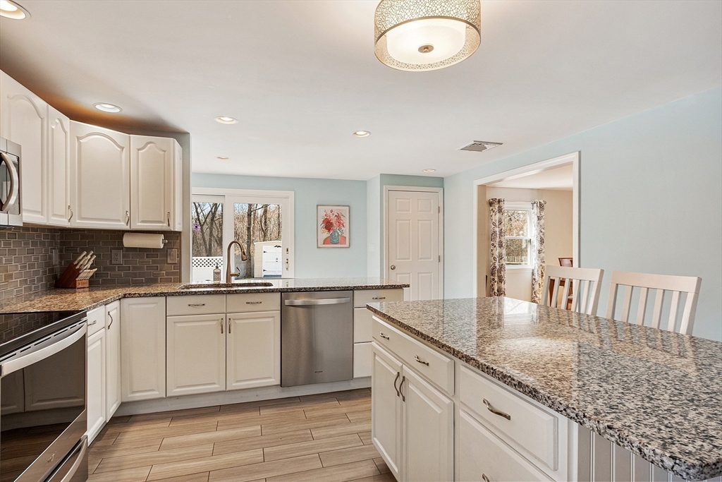 24 Washington Avenue Ashland, MA 01721 - Photo 4 of 30 a kitchen with granite countertop a sink and cabinets