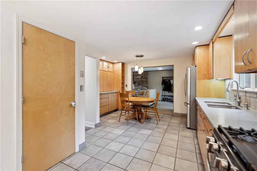 2 Lear Drive Pittsburgh, PA 15235 - Photo 13 of 43 a kitchen with a sink outdoor dining table and chairs