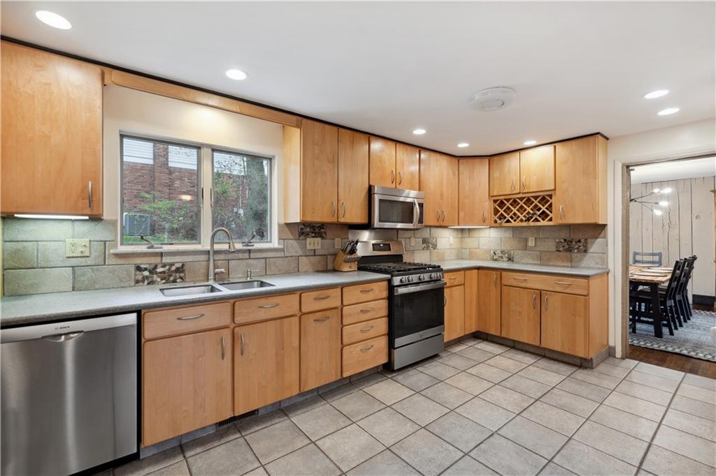 2 Lear Drive Pittsburgh, PA 15235 - Photo 15 of 43 a kitchen with a sink window and cabinets