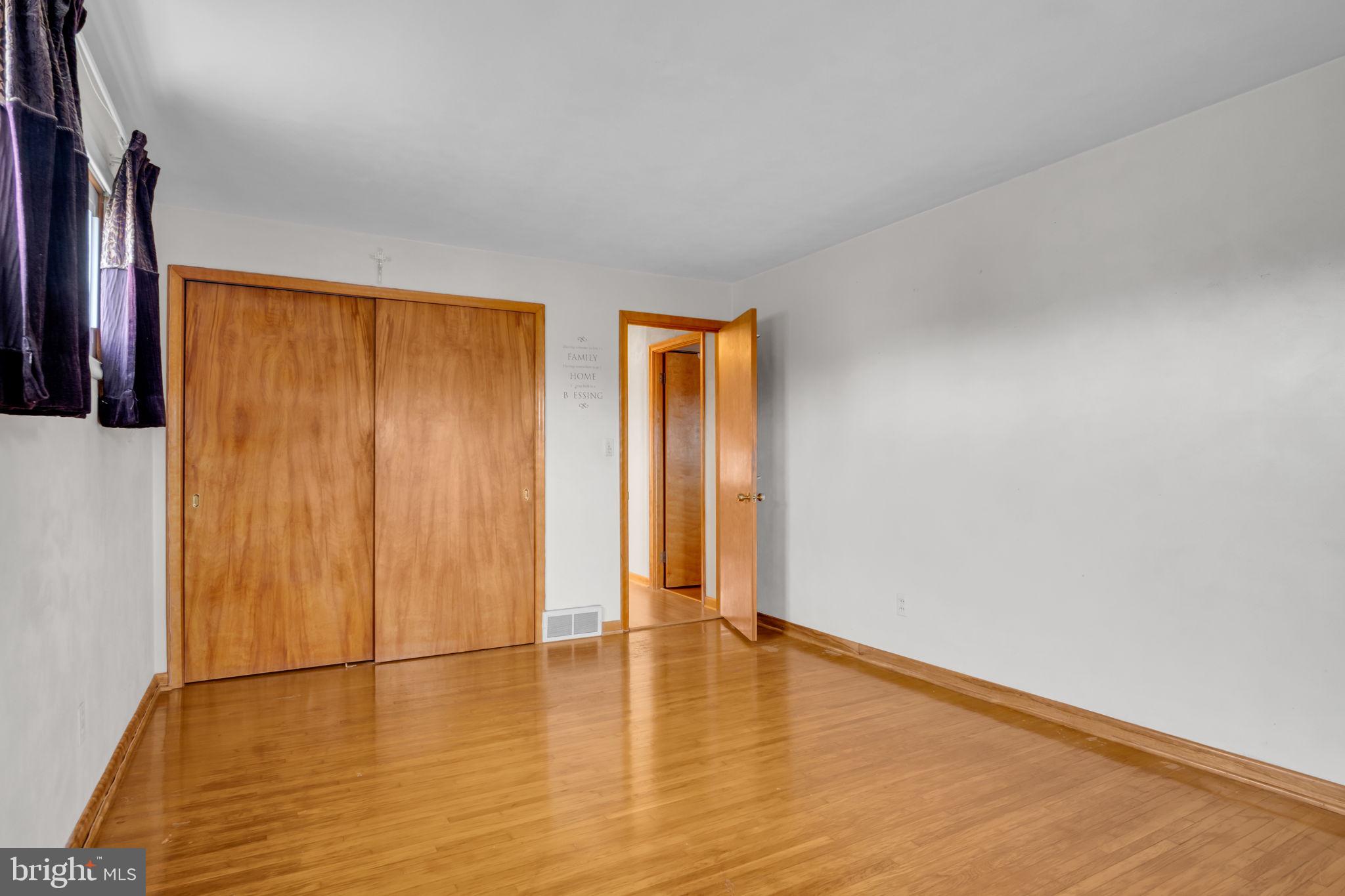 301 East Elm Avenue Hanover, PA 17331 - Photo 16 of 46 an empty room with wooden floor and closet