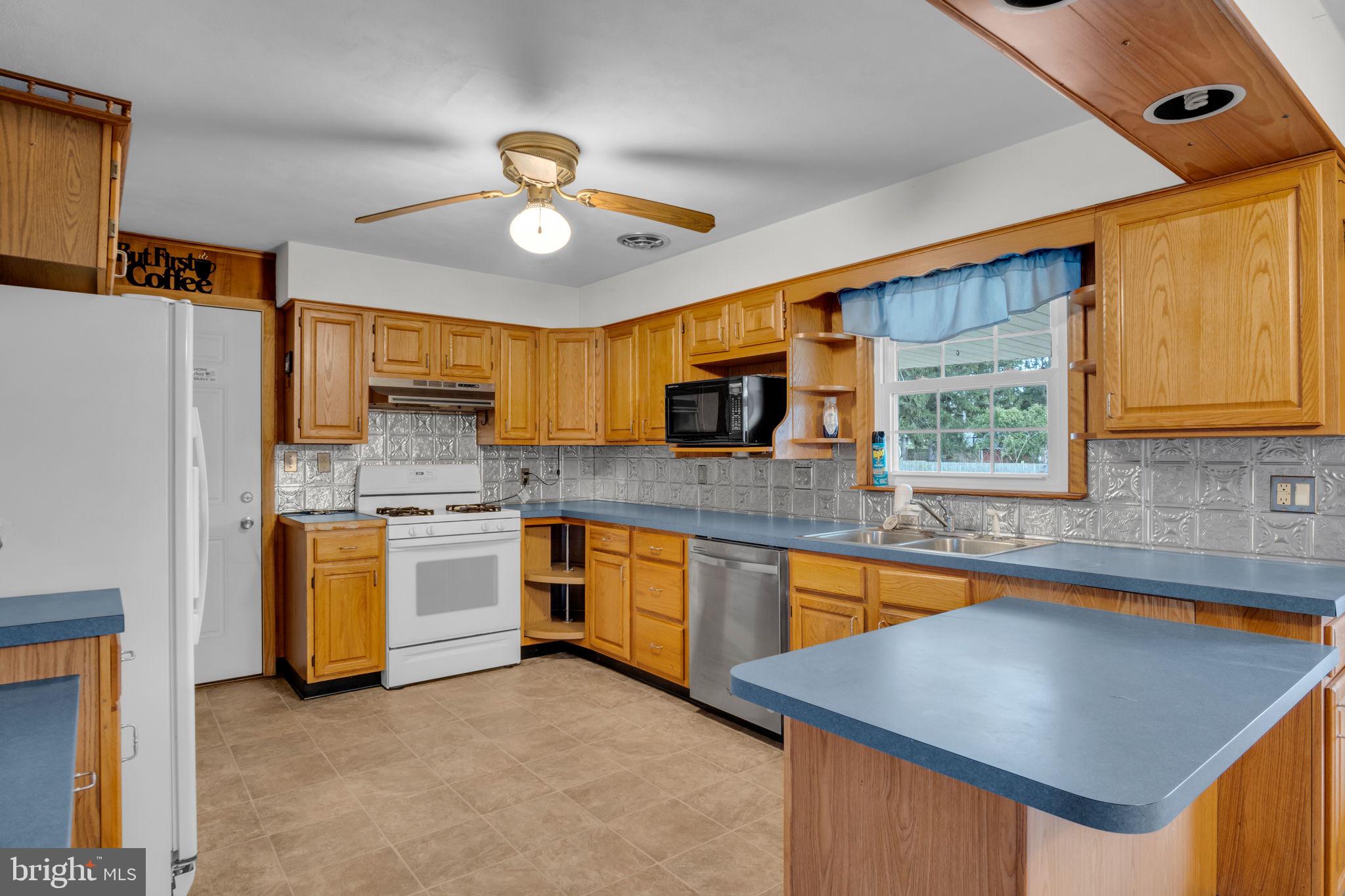 301 East Elm Avenue Hanover, PA 17331 - Photo 3 of 46 a kitchen with stainless steel appliances granite countertop stove top oven a sink dishwasher and a refrigerator with wooden cabinets