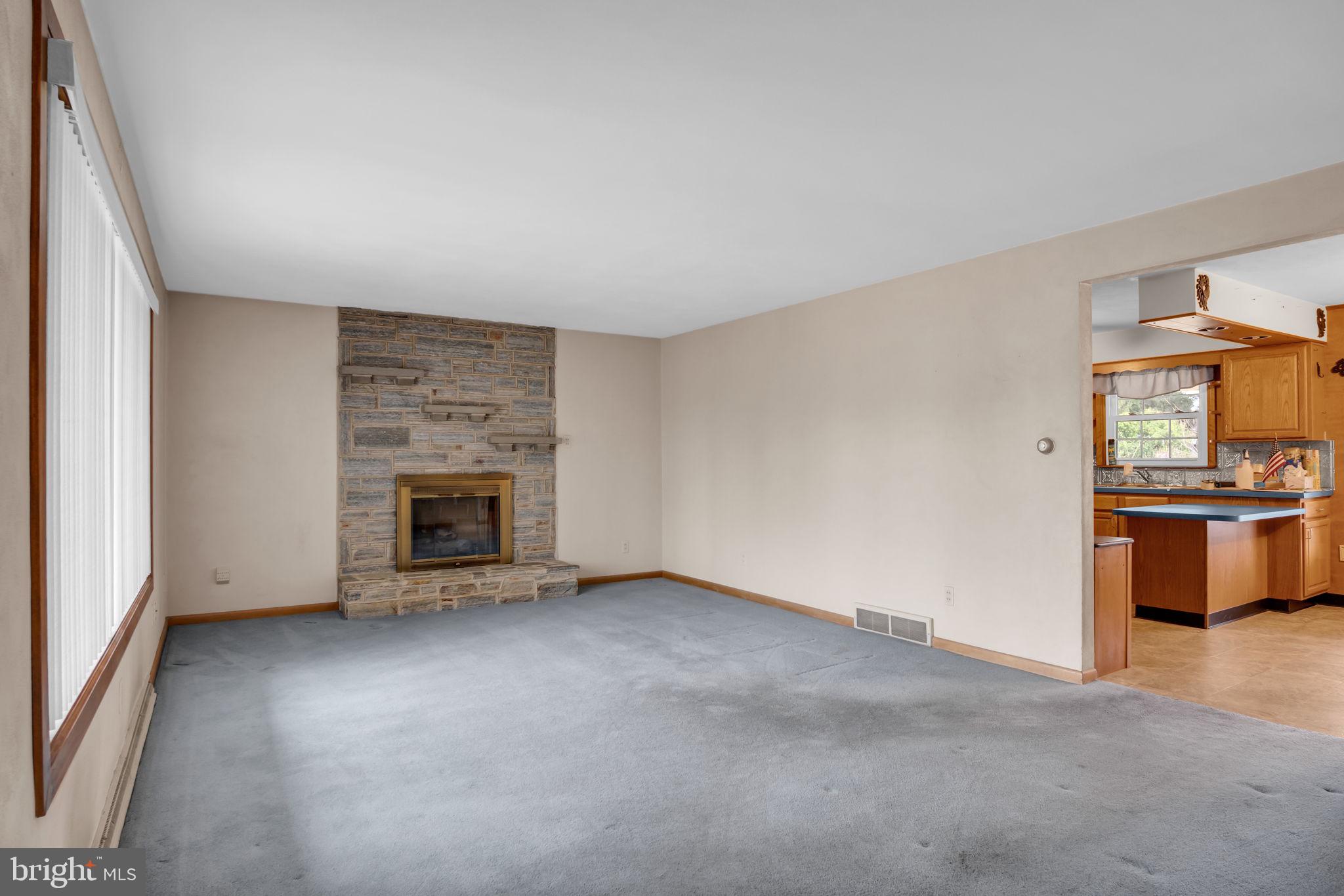 301 East Elm Avenue Hanover, PA 17331 - Photo 9 of 46 an empty room with a fireplace and kitchen view