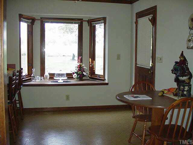 4506 Pearces Road Zebulon, NC 27597 - Photo 4 of 10 a view of a dining room with furniture and window