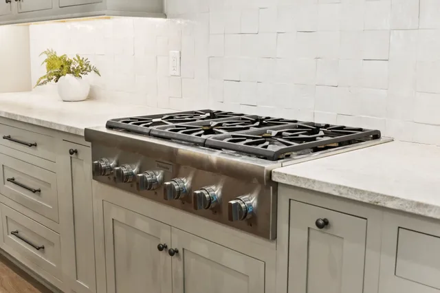 a close view of a stove a microwave and cabinets