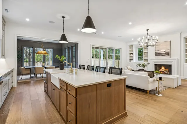 a dining room with furniture a chandelier and wooden floor