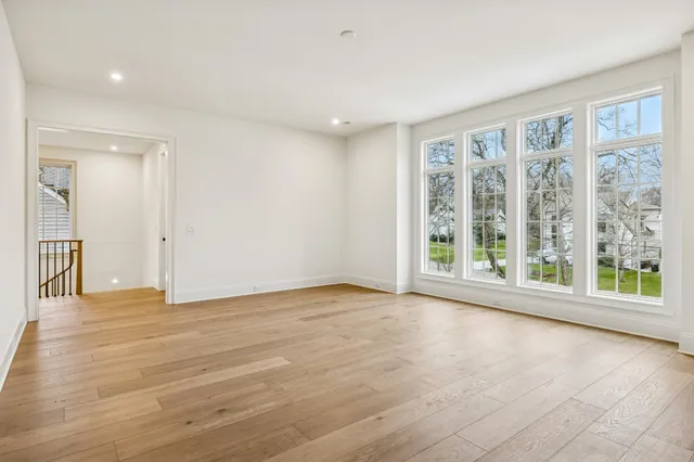a kitchen with granite countertop white cabinets and window