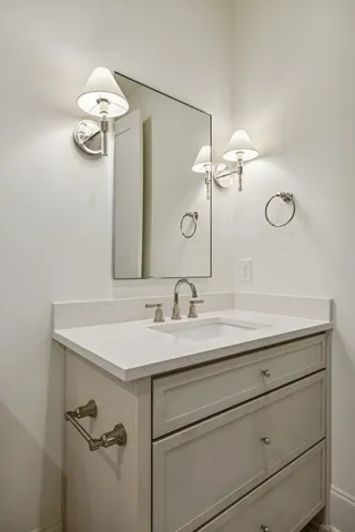a bathroom with a granite countertop sink a toilet and shower