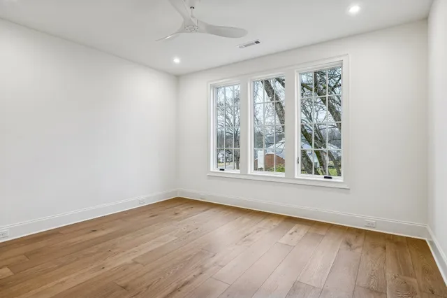 a spacious bedroom with a bed and a large window
