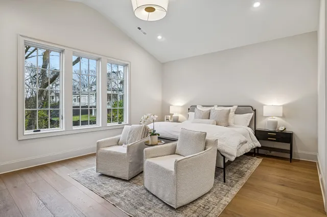 a spacious bedroom with a large bed and a large window