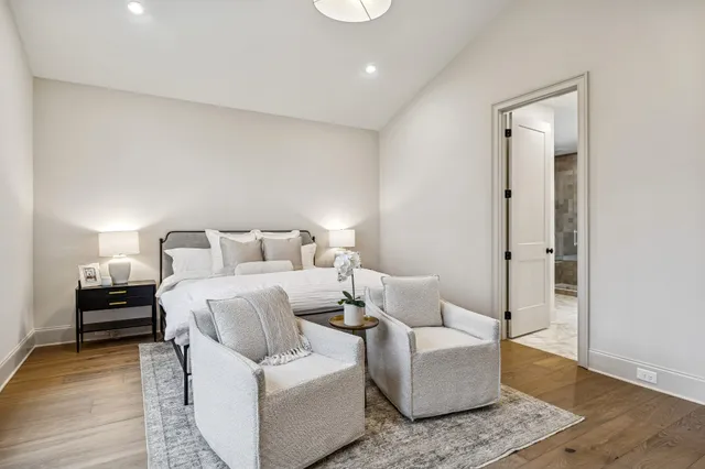 a bathroom with a tub a sink a mirror and a shower