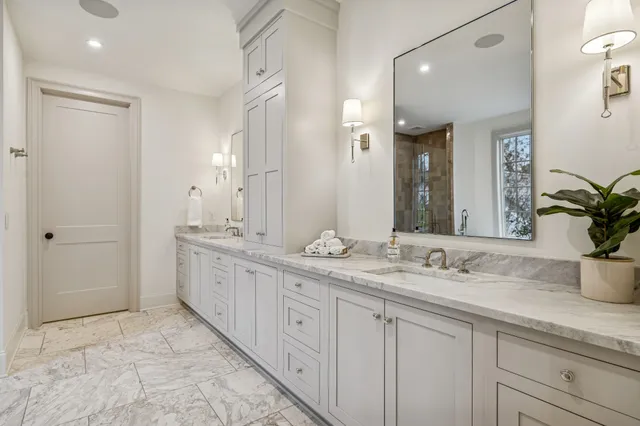 a large bathroom with a large mirror vanity and shower