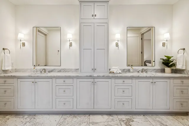 a spacious bathroom with a granite countertop sink mirror and a