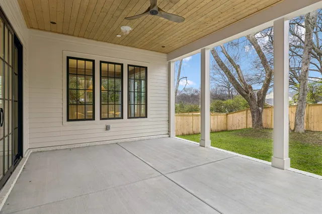 a view of a hallway with wooden floor windows and a chandelier