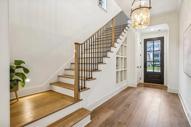 a view of entryway and hall with wooden floor