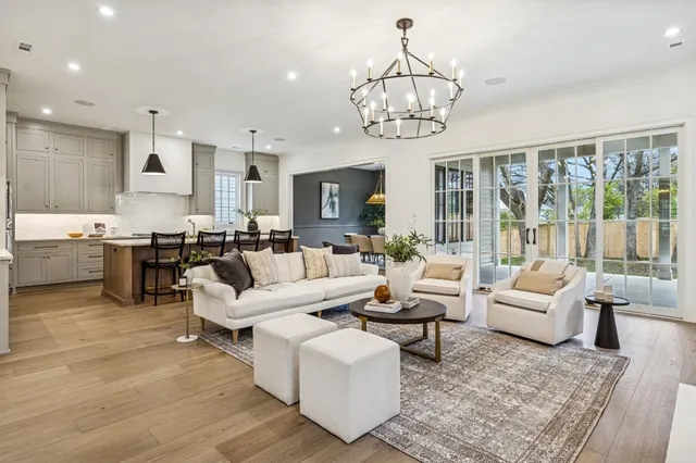 a living room with fireplace furniture and a chandelier