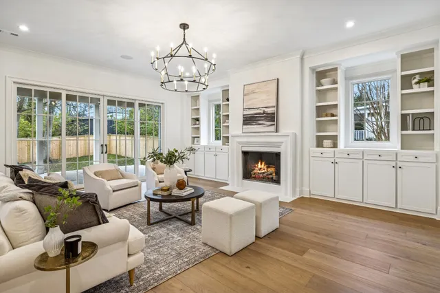 a living room with fireplace furniture and a chandelier