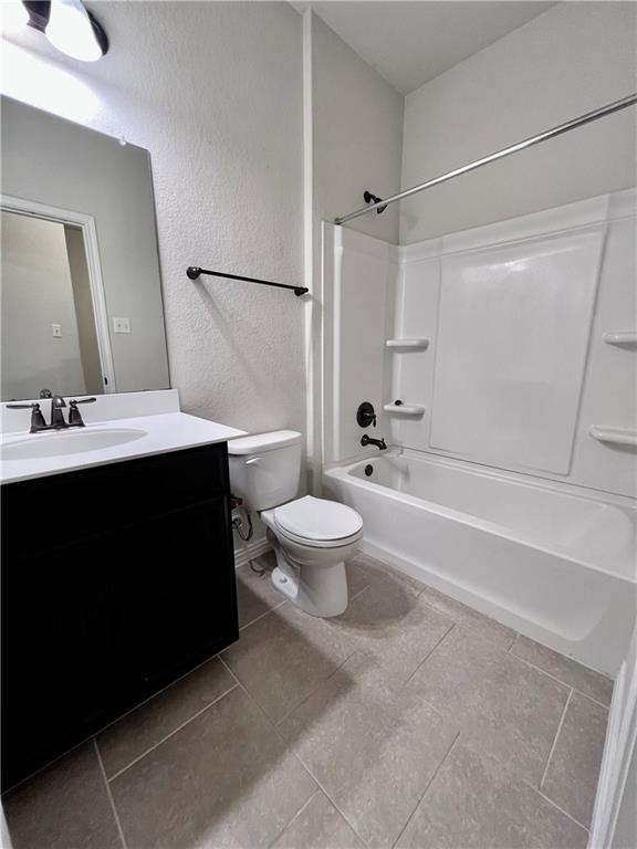 19733 Cherubini Trail Pflugerville, TX 78660 - Photo 19 of 24 Full bathroom featuring shower / tub combination, vanity, a textured wall, and light tile patterned floors