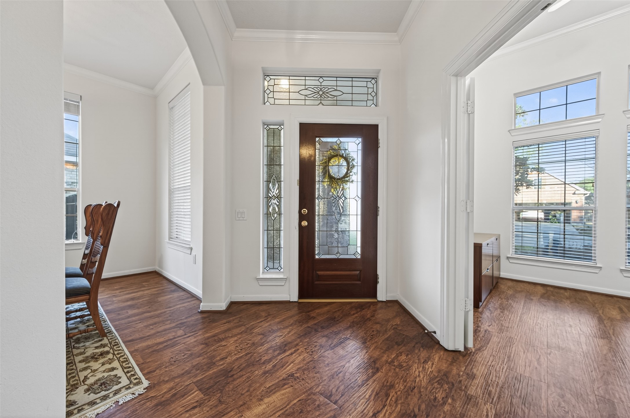 27 Sovereign Way Conroe, TX 77384 - Photo 3 of 49 This photo showcases a bright, inviting entryway with a stylish wooden door featuring decorative glass panels. Perfect for a welcoming first impression.