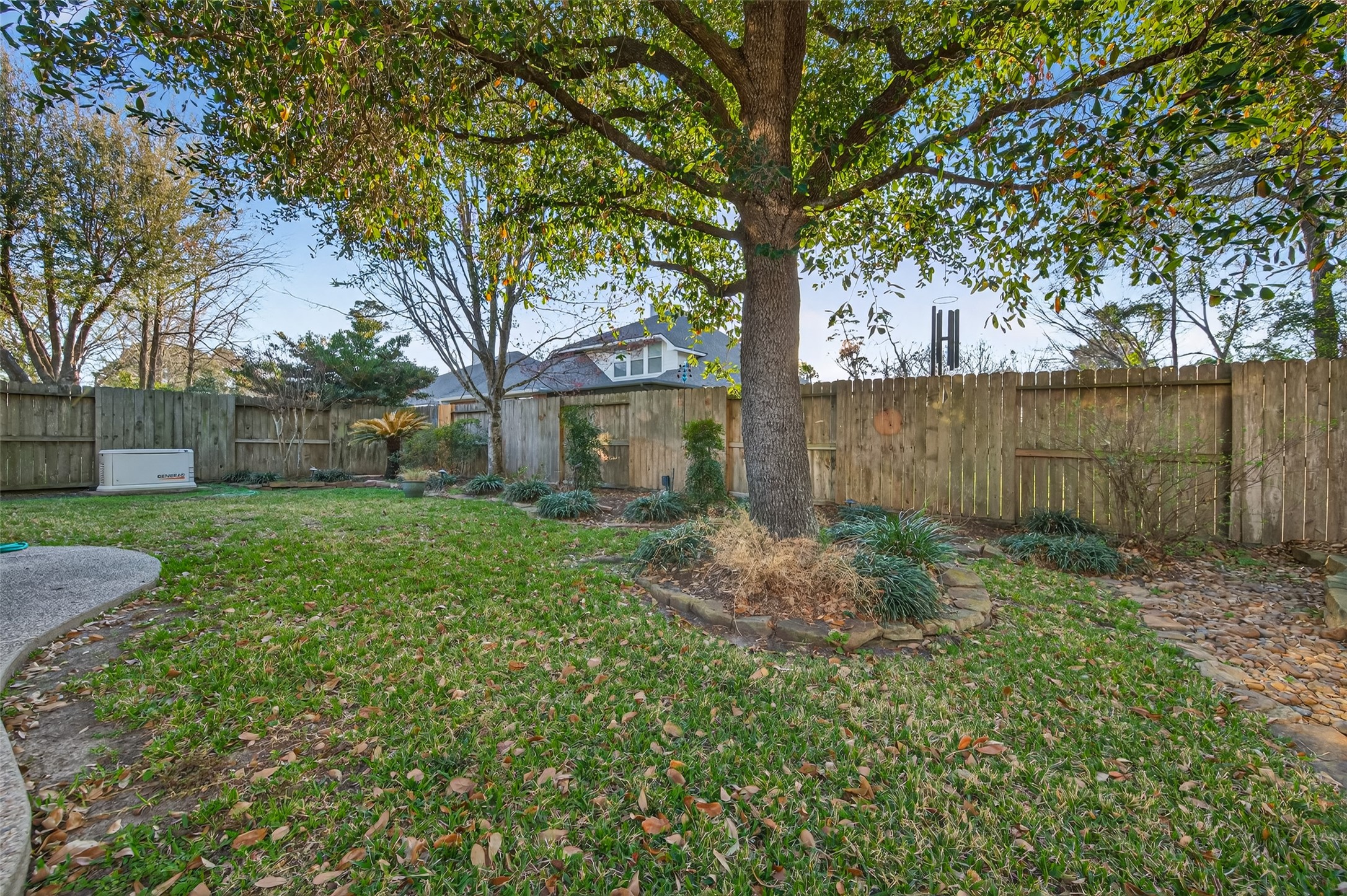 27 Sovereign Way Conroe, TX 77384 - Photo 37 of 49 Spacious backyard with lush grass and mature trees.