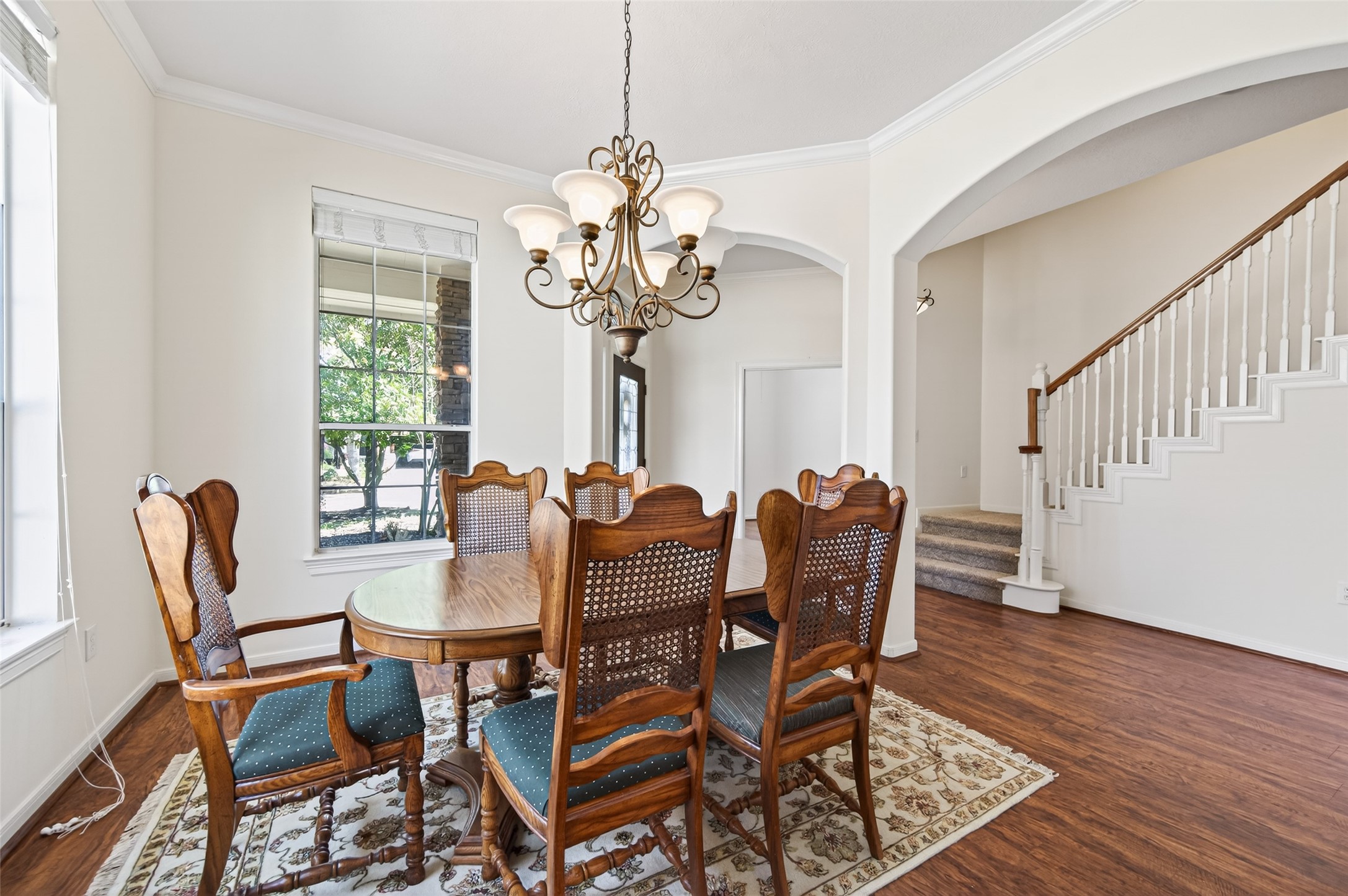 27 Sovereign Way Conroe, TX 77384 - Photo 6 of 49 This inviting dining area features a chandelier and large windows that provide plenty of natural light.