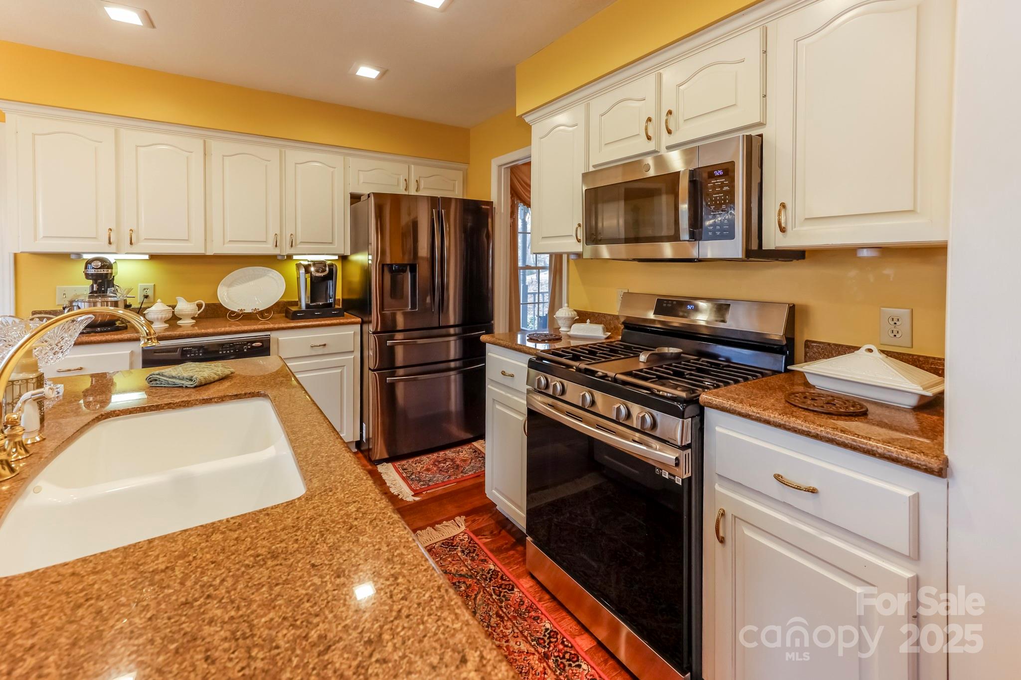 173 Sherry Street Rutherfordton, NC 28139 - Photo 16 of 33 a kitchen with stainless steel appliances granite countertop a stove a sink and a microwave