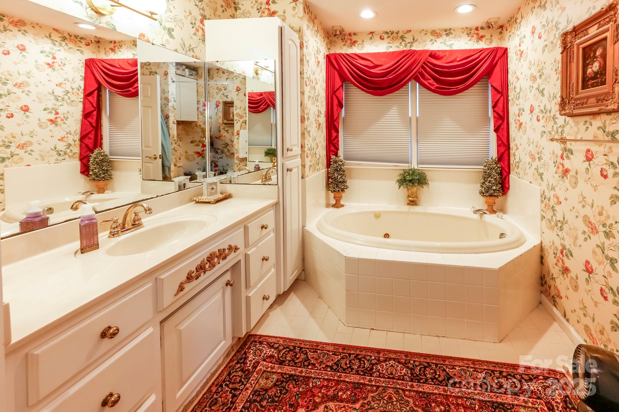 173 Sherry Street Rutherfordton, NC 28139 - Photo 25 of 33 a bathroom with a bathtub sink and a mirror