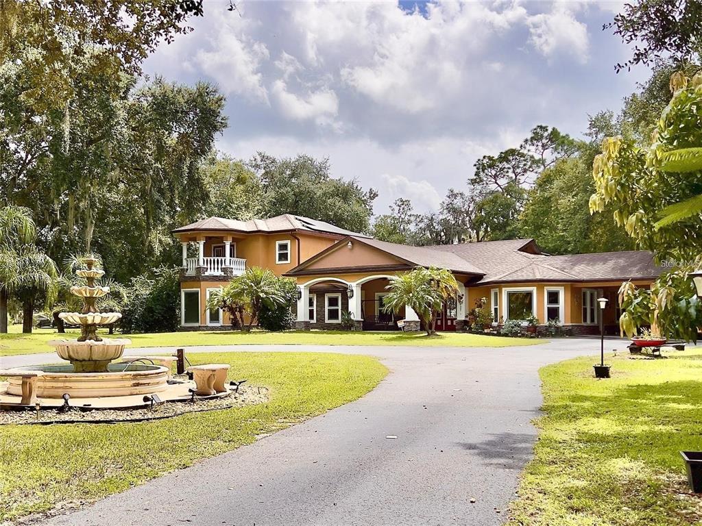 a front view of a house with swimming pool and porch