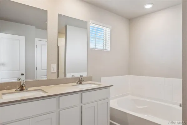 a bathroom with a shower a bathtub and a shower