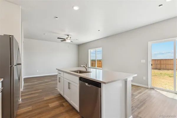 a kitchen with a sink appliances and cabinets