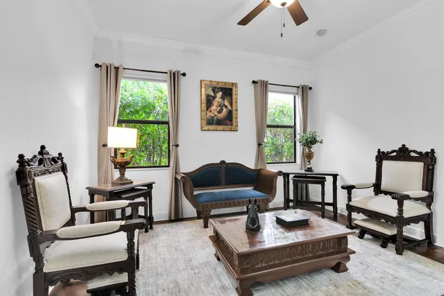 a spacious bedroom with a bed and a table in it with window