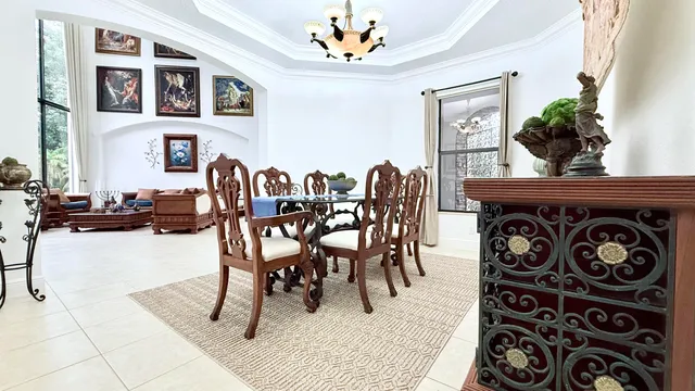 a living room with furniture kitchen view and a wooden floor