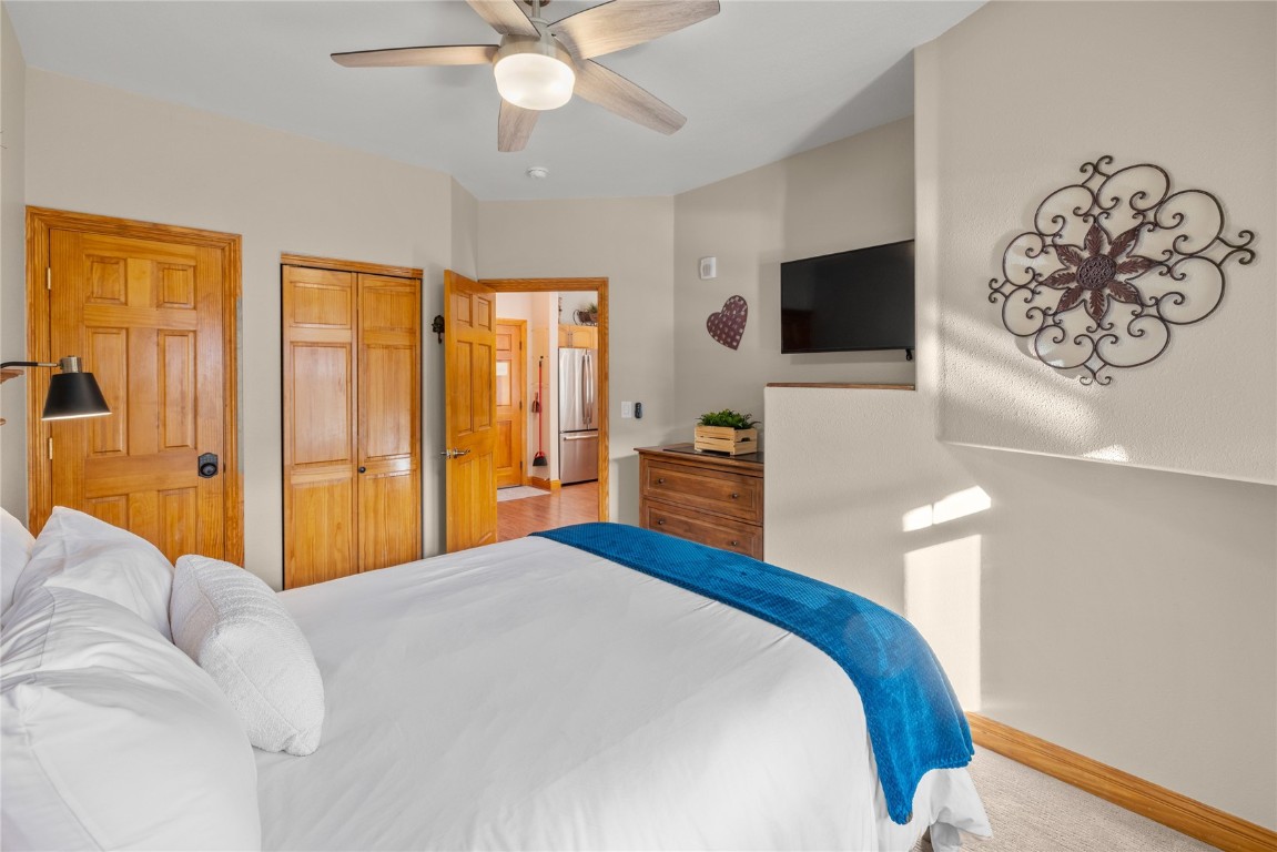 22714 Highway 6, Unit 5989 Keystone, CO 80435 - Photo 18 of 37 a bedroom with a large bed and a flat screen tv