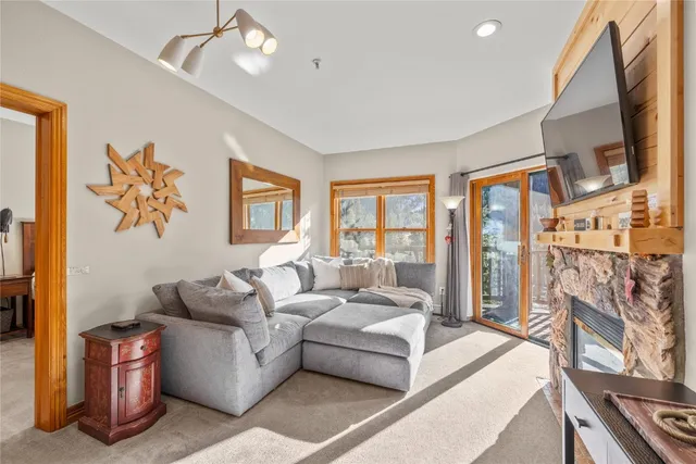 a living room with fireplace furniture and a flat screen tv