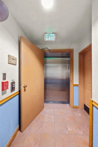 a living room with fireplace furniture and a chandelier
