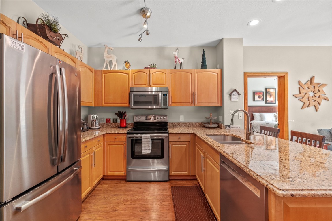 22714 Highway 6, Unit 5989 Keystone, CO 80435 - Photo 7 of 37 a kitchen with stainless steel appliances granite countertop a refrigerator a stove top oven a sink and dishwasher