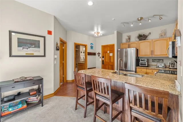 a kitchen with stainless steel appliances granite countertop a refrigerator and a stove top oven