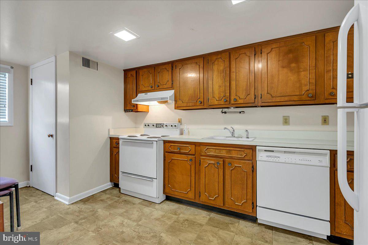 1403 Shallcross Avenue, Unit 310 Wilmington, DE 19806 - Photo 11 of 21 a kitchen with granite countertop cabinets stainless steel appliances and wooden cabinets