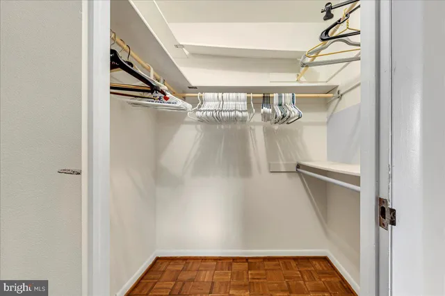 a view of walk in closet with empty racks